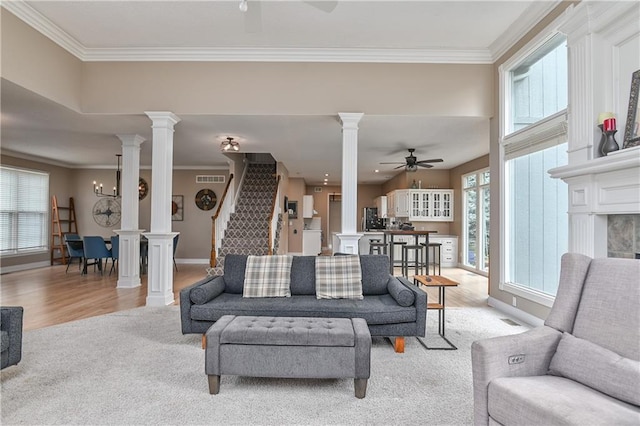 5303 Hallet St, Shawnee, KS 66216 - living room featuring a ceiling fan, decorative columns, ornamental molding, light wood finished floors, and stairway