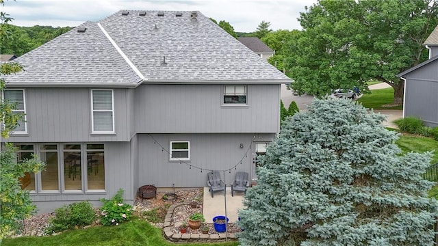 5303 Hallet St, Shawnee, KS 66216 - rear view of house featuring roof with shingles and a patio area