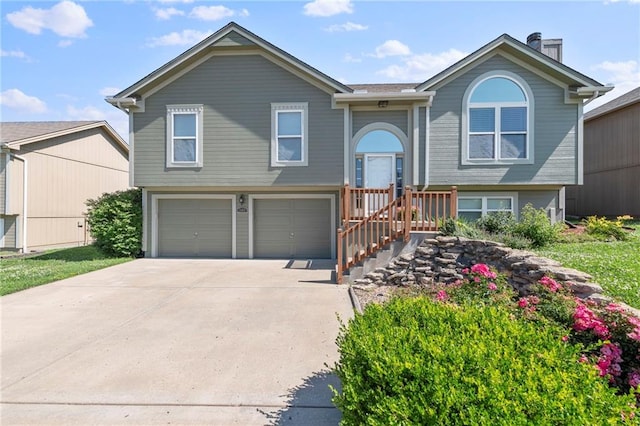 103 Bridgeport Dr, Smithville, MO 64089 - bi-level home with a garage, driveway, and a chimney