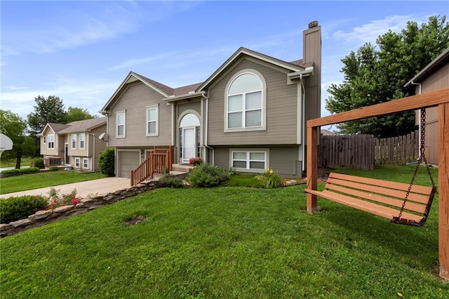 103 Bridgeport Dr, Smithville, MO 64089 - bi-level home with a chimney, concrete driveway, and a garage