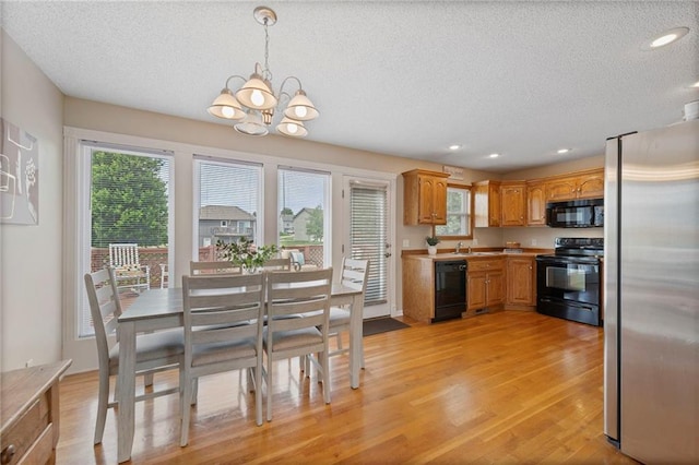 103 Bridgeport Dr, Smithville, MO 64089 - dining room with a textured ceiling, light wood-type flooring, a chandelier, and recessed lighting