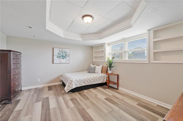 103 Bridgeport Dr, Smithville, MO 64089 - bedroom with wood finished floors, a tray ceiling, and a textured ceiling