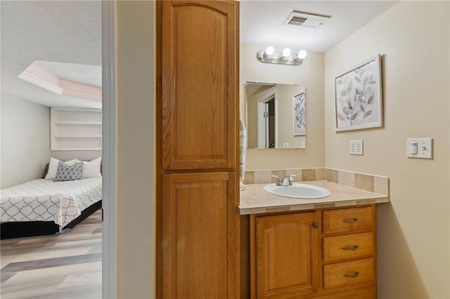 103 Bridgeport Dr, Smithville, MO 64089 - bathroom featuring vanity, wood finished floors, and ensuite bath