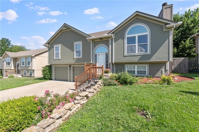 103 Bridgeport Dr, Smithville, MO 64089 - bi-level home with concrete driveway, an attached garage, and a chimney