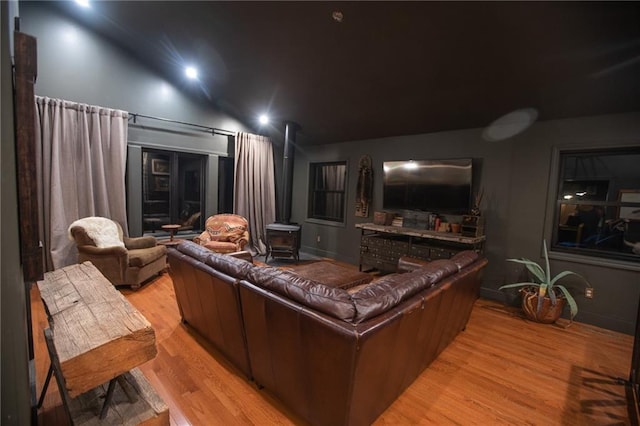 11001 S Perdue Rd, Grain Valley, MO 64029 - home theater with light wood-style flooring and a wood stove
