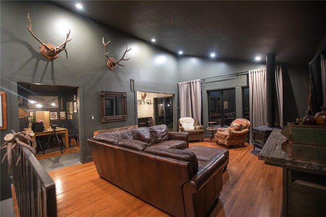11001 S Perdue Rd, Grain Valley, MO 64029 - living room featuring high vaulted ceiling, wood finished floors, and recessed lighting