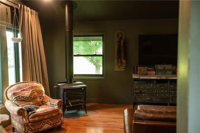 11001 S Perdue Rd, Grain Valley, MO 64029 - sitting room with a wood stove and wood finished floors