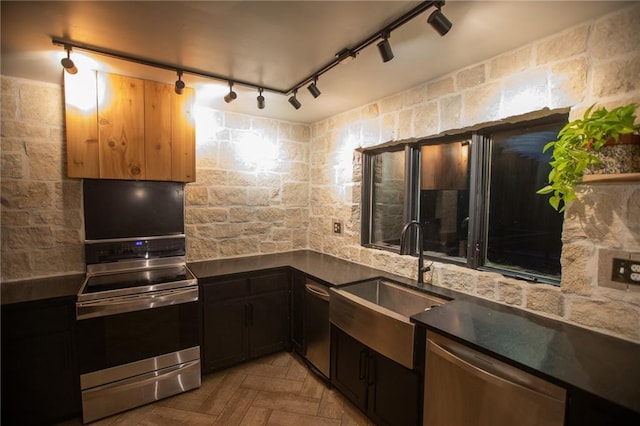 11001 S Perdue Rd, Grain Valley, MO 64029 - kitchen with appliances with stainless steel finishes, dark countertops, rail lighting, and decorative backsplash