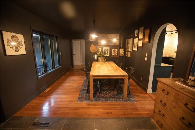 11001 S Perdue Rd, Grain Valley, MO 64029 - dining area with arched walkways and wood finished floors