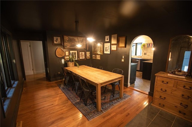 11001 S Perdue Rd, Grain Valley, MO 64029 - dining space featuring arched walkways and light wood-style floors
