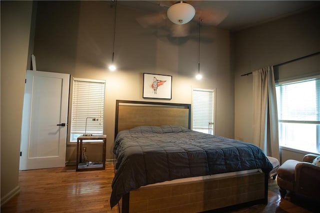 11001 S Perdue Rd, Grain Valley, MO 64029 - bedroom featuring a towering ceiling, wood finished floors, and a ceiling fan