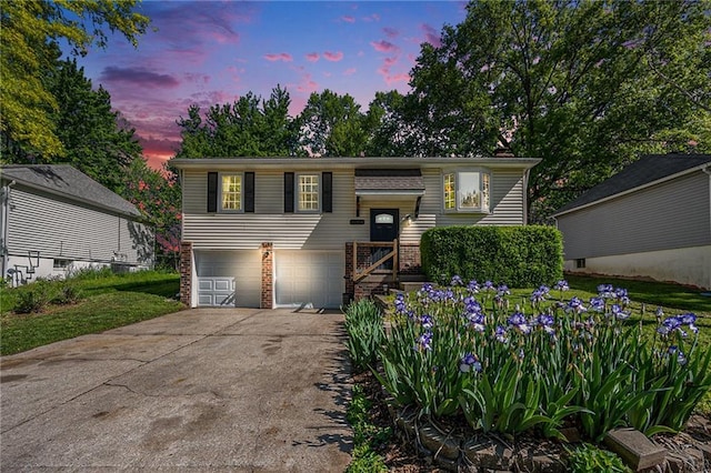 20308 E 17th Ter N, Independence, MO 64056 - split foyer home featuring driveway, a garage, and brick siding