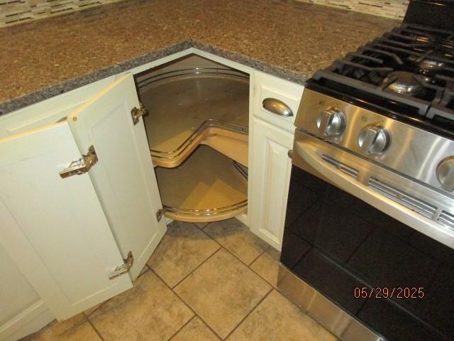 19005 E 18th Ter N, Independence, MO 64058 - kitchen view of stainless steel gas range oven, white cabinets, and dark stone countertops