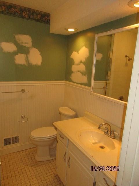 19005 E 18th Ter N, Independence, MO 64058 - full bath with a wainscoted wall, vanity, toilet, tile patterned flooring, and a shower with shower door