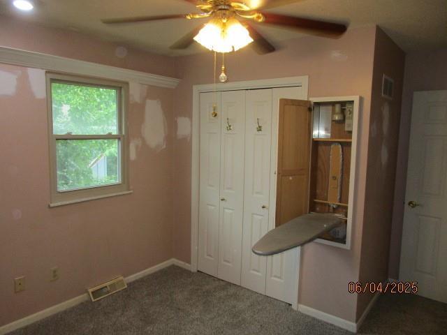 19005 E 18th Ter N, Independence, MO 64058 - unfurnished bedroom with carpet flooring, a closet, and a ceiling fan