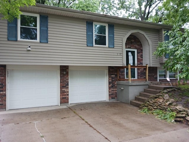 2912 Iva Dr, Independence, MO 64057 - raised ranch with brick siding, an attached garage, and driveway