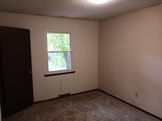2912 Iva Dr, Independence, MO 64057 - empty room with dark carpet and a textured ceiling