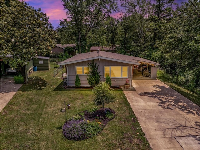 1112 Anderson St, Warrensburg, MO 64093 - bungalow-style house featuring driveway, a front lawn, and an attached carport
