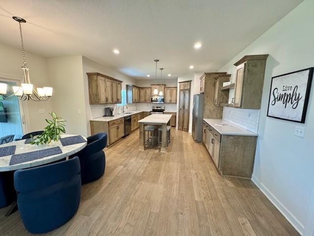 24840 W 178th Ct, Gardner, KS 66030 - kitchen featuring stainless steel appliances, light wood-style floors, a chandelier, light countertops, and recessed lighting