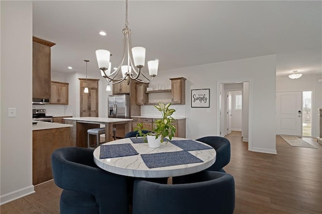 24840 W 178th Ct, Gardner, KS 66030 - dining area featuring a chandelier, dark wood-style flooring, plenty of natural light, and recessed lighting