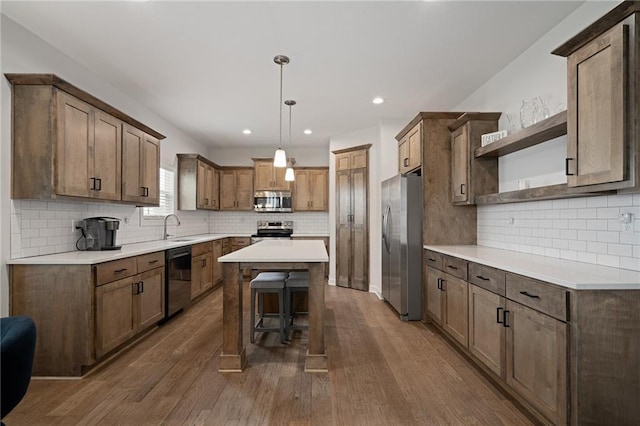 24840 W 178th Ct, Gardner, KS 66030 - kitchen with stainless steel appliances, open shelves, tasteful backsplash, a center island, and a breakfast bar area