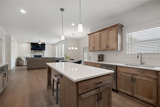 24840 W 178th Ct, Gardner, KS 66030 - kitchen featuring dishwasher, a fireplace, backsplash, dark wood-style flooring, and recessed lighting