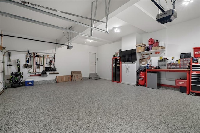 24840 W 178th Ct, Gardner, KS 66030 - garage featuring a garage door opener and a workshop area