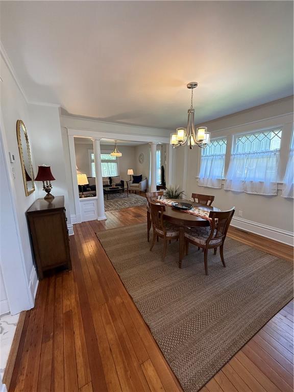 928 S 6th St, Atchison, KS 66002 - dining room featuring hardwood / wood-style flooring, healthy amount of natural light, and a chandelier