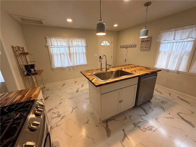 928 S 6th St, Atchison, KS 66002 - kitchen featuring stainless steel appliances, light marble finish floors, recessed lighting, a kitchen island with sink, and pendant lighting