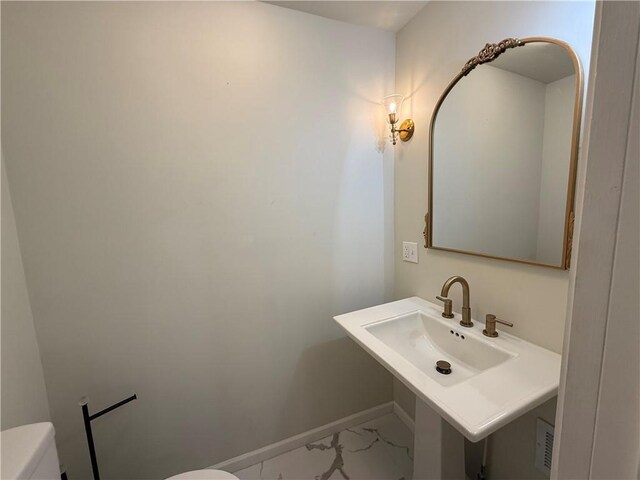 928 S 6th St, Atchison, KS 66002 - bathroom featuring toilet and marble finish flooring