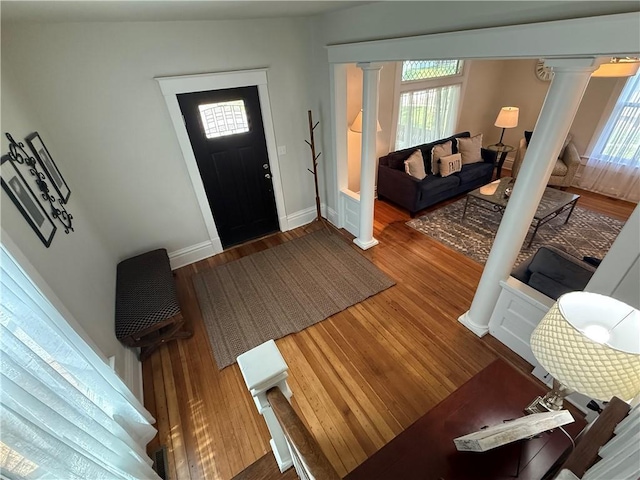 928 S 6th St, Atchison, KS 66002 - foyer with ornate columns, wood finished floors, and healthy amount of natural light