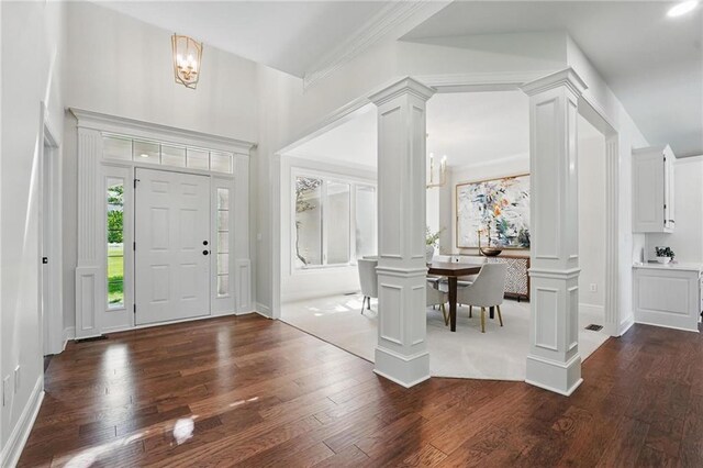 15340 Knox St, Overland Park, KS 66221 - foyer entrance featuring decorative columns, dark wood finished floors, and a chandelier