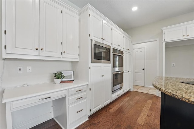 15340 Knox St, Overland Park, KS 66221 - kitchen with appliances with stainless steel finishes, dark wood-style floors, white cabinets, light countertops, and recessed lighting