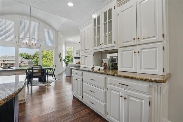 15340 Knox St, Overland Park, KS 66221 - kitchen with white cabinetry, glass insert cabinets, dark wood finished floors, dark stone counters, and recessed lighting