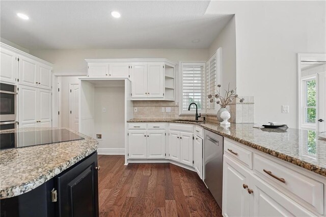 15340 Knox St, Overland Park, KS 66221 - kitchen featuring stainless steel dishwasher, white cabinets, light stone countertops, dark wood-style flooring, and recessed lighting