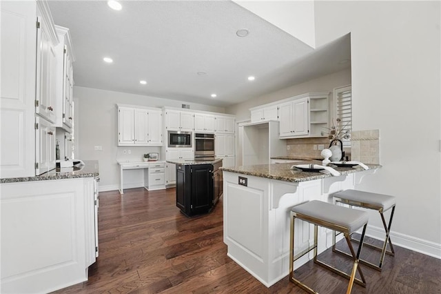 15340 Knox St, Overland Park, KS 66221 - kitchen with stainless steel appliances, open shelves, stone countertops, a peninsula, and dark wood-style flooring