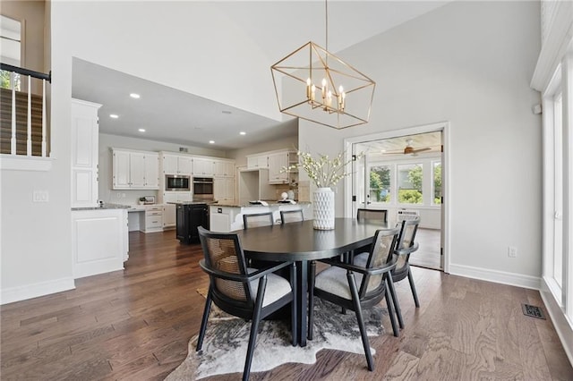 15340 Knox St, Overland Park, KS 66221 - dining space with high vaulted ceiling, dark wood finished floors, a chandelier, recessed lighting, and ceiling fan
