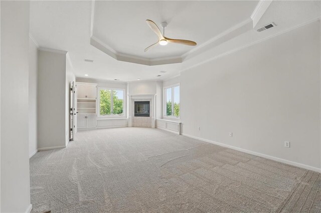 15340 Knox St, Overland Park, KS 66221 - unfurnished living room with ornamental molding, a raised ceiling, a ceiling fan, light carpet, and recessed lighting