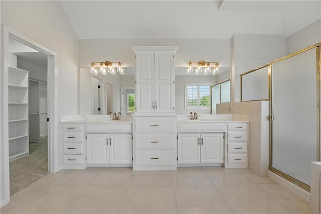 15340 Knox St, Overland Park, KS 66221 - bathroom featuring vanity, a shower stall, tile patterned floors, and a walk in closet