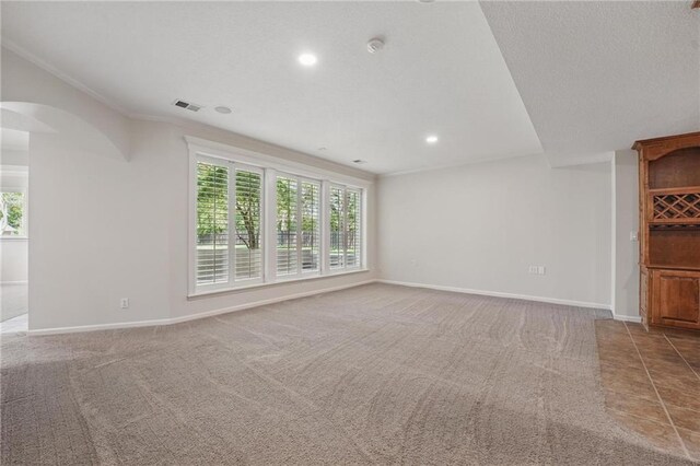 15340 Knox St, Overland Park, KS 66221 - unfurnished living room with healthy amount of natural light, carpet floors, arched walkways, crown molding, and recessed lighting