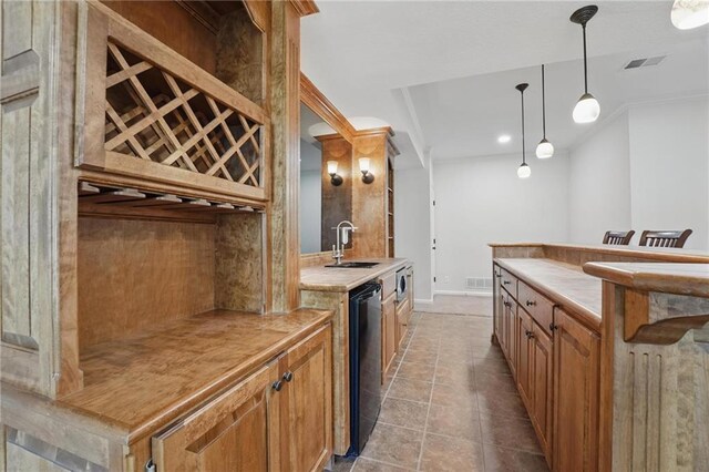 15340 Knox St, Overland Park, KS 66221 - kitchen featuring stainless steel microwave, light countertops, hanging light fixtures, light tile patterned floors, and recessed lighting