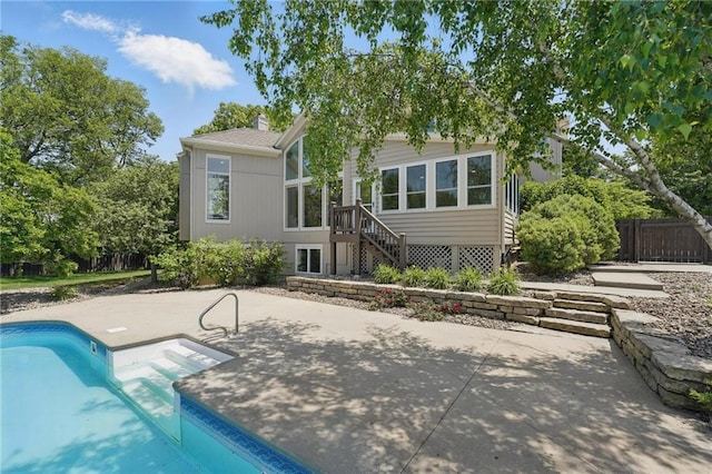 15340 Knox St, Overland Park, KS 66221 - back of house with an outdoor pool, a patio area, and a chimney