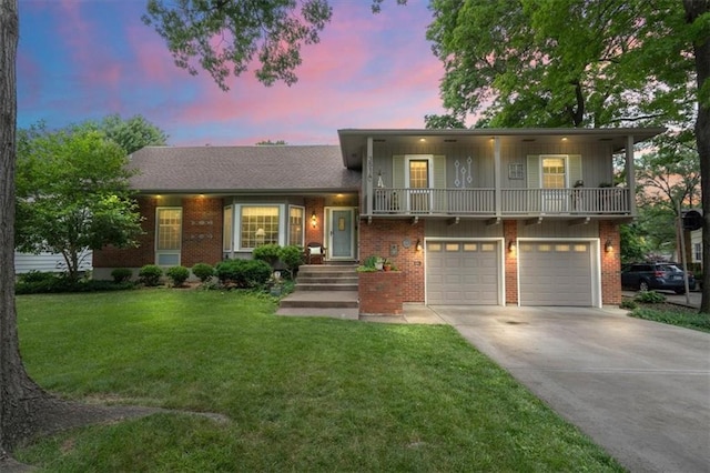 3514 W 47th Pl, Roeland Park, KS 66205 - split level home featuring concrete driveway, an attached garage, a balcony, a front lawn, and brick siding