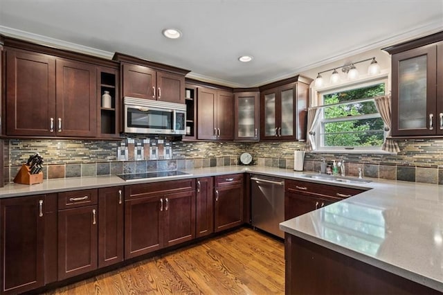 3514 W 47th Pl, Roeland Park, KS 66205 - kitchen with stainless steel appliances, light wood finished floors, backsplash, glass insert cabinets, and recessed lighting