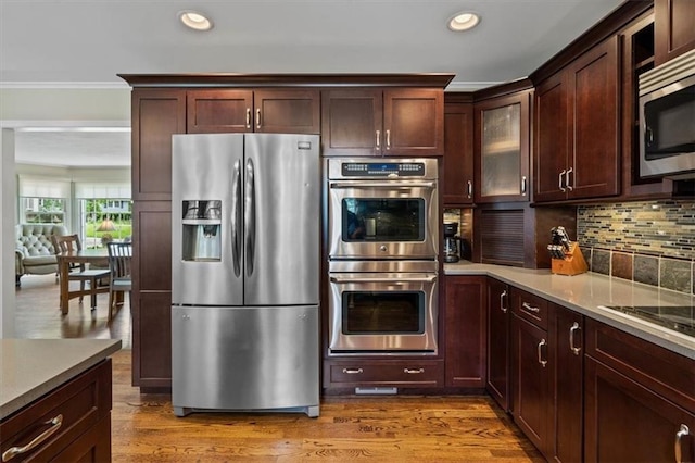3514 W 47th Pl, Roeland Park, KS 66205 - kitchen featuring stainless steel appliances, ornamental molding, decorative backsplash, recessed lighting, and wood finished floors