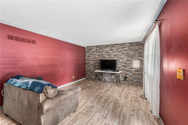 308 E Meadow St, Smithville, MO 64089 - living area with wood finished floors, a textured ceiling, and crown molding