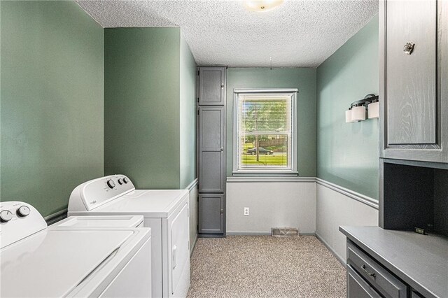 308 E Meadow St, Smithville, MO 64089 - laundry room with washing machine and dryer, a textured ceiling, carpet flooring, and cabinet space