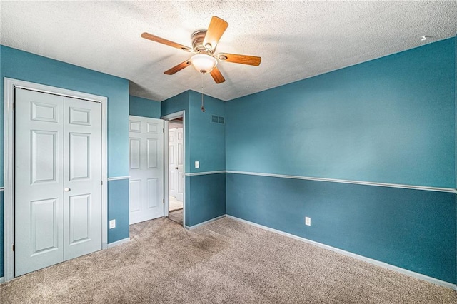 308 E Meadow St, Smithville, MO 64089 - unfurnished bedroom with carpet floors, a closet, a textured ceiling, and a ceiling fan