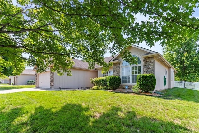 1111 SW 13th St, Oak Grove, MO 64075 - ranch-style house with stone siding, concrete driveway, and an attached garage