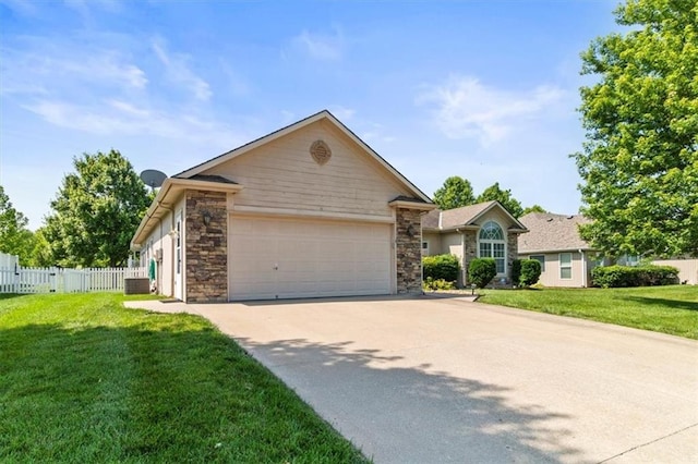 1111 SW 13th St, Oak Grove, MO 64075 - ranch-style house featuring a garage, driveway, and stone siding